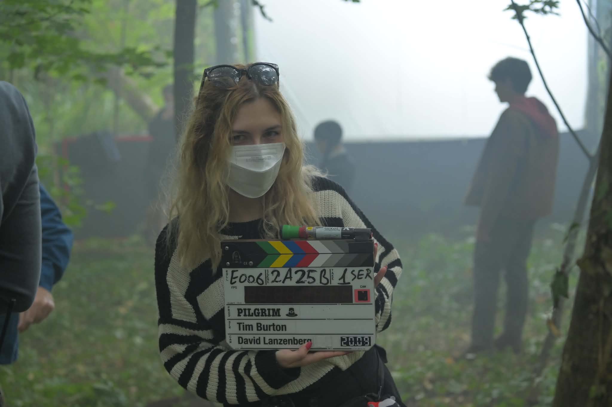Adelina on location, clapperboard in hand
